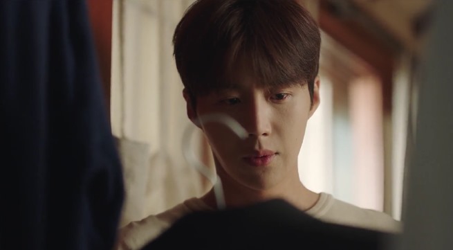 Hometown-Cha-Cha-Cha-Episode-2-as-Chief-Hong-looks-at-the-suit-in-his-closet