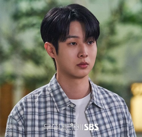 a still of choi woo shik in would you marry me episode 11 - facing the camera and wearing a blue checked shirt